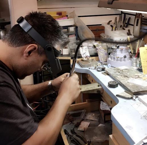 David at the jeweler’s bench, working on a piece under a magnifying visor